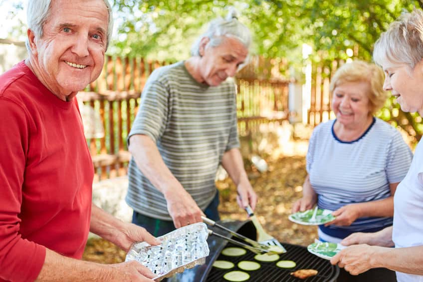 Seniors barbecue at a garden party in summer Seniors barbecue at a garden party in summer